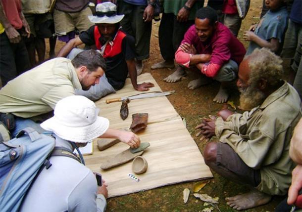 El Dr. Ben Shaw y algunos lugareños examinan algunos de los artefactos de Papua Nueva Guinea desenterrados en el sitio de excavación Waim en las tierras altas del norte. (UNSW /Ben Shaw)