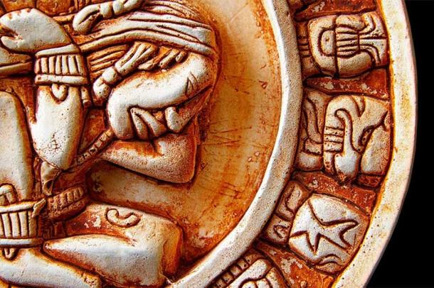 Close-up of glyphs on a Mayan calendar. (zimmytws / Adobe Stock)